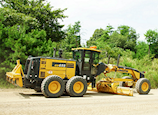 New Komatsu GD655-7 Motor Grader in front of trees